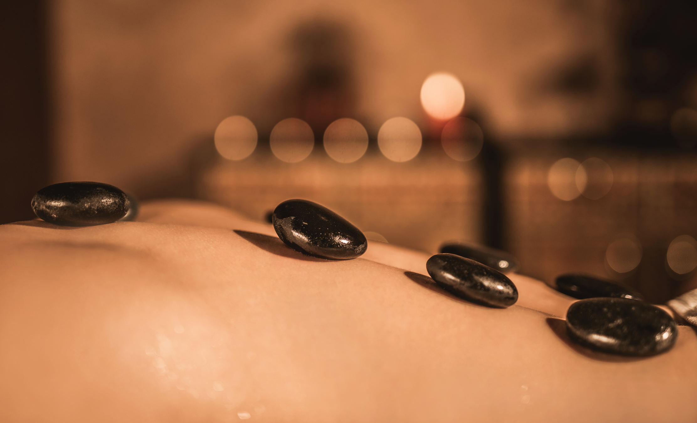 Hot stone massage therapy close up